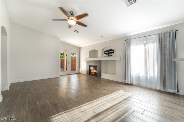 4360 Meadowlark Wing Way N, Las Vegas, NV 89084 - unfurnished living room featuring a ceiling fan, wood finished floors, vaulted ceiling, a tiled fireplace, and baseboards