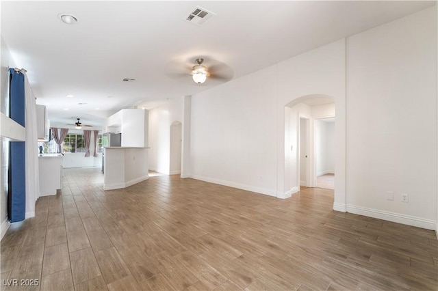 4360 Meadowlark Wing Way N, Las Vegas, NV 89084 - unfurnished living room featuring arched walkways, a ceiling fan, light wood finished floors, and recessed lighting