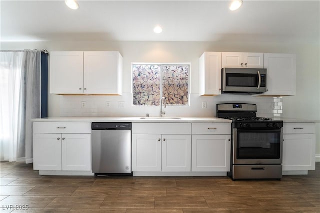 4360 Meadowlark Wing Way N, Las Vegas, NV 89084 - kitchen featuring stainless steel appliances, a sink, white cabinetry, backsplash, and recessed lighting