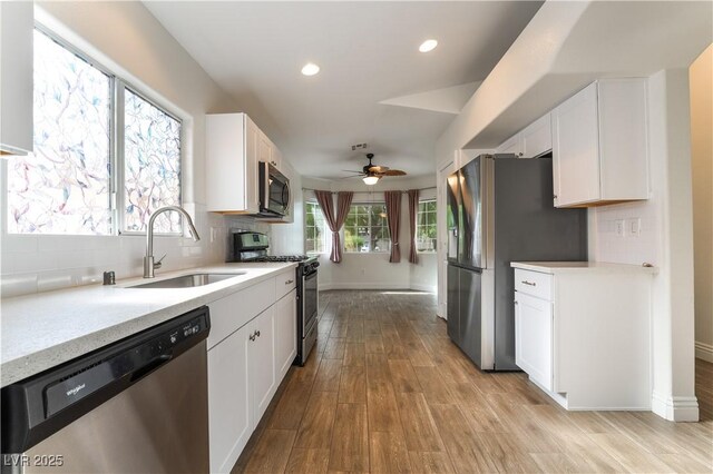 4360 Meadowlark Wing Way N, Las Vegas, NV 89084 - kitchen featuring appliances with stainless steel finishes, a sink, ceiling fan, light countertops, and white cabinets