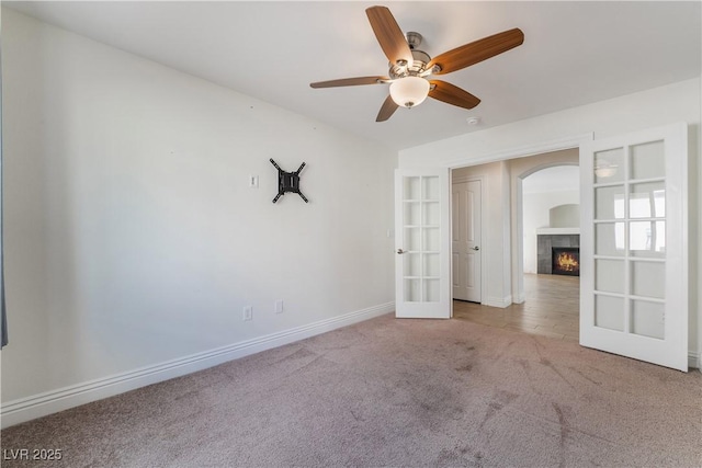 4360 Meadowlark Wing Way N, Las Vegas, NV 89084 - spare room with french doors, carpet floors, a fireplace, baseboards, and a ceiling fan
