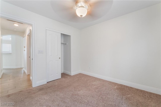 4360 Meadowlark Wing Way N, Las Vegas, NV 89084 - unfurnished bedroom with arched walkways, carpet, baseboards, a closet, and ceiling fan