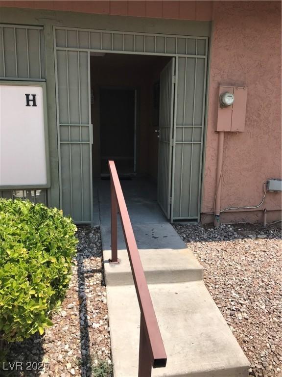 property entrance featuring stucco siding and board and batten siding
