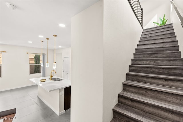 stairway featuring recessed lighting, tile patterned flooring, and baseboards