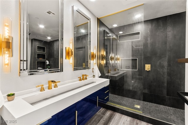 full bathroom featuring recessed lighting, wood finished floors, visible vents, vanity, and a walk in shower