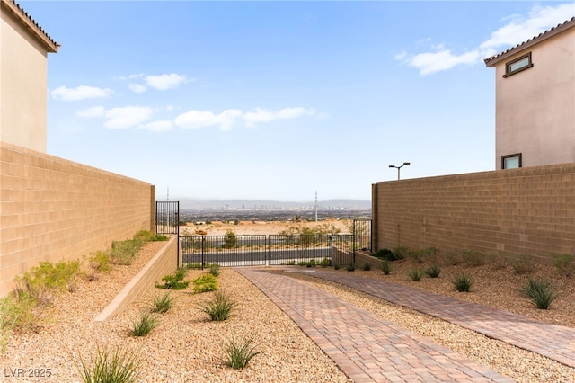 view of yard with fence and a gate