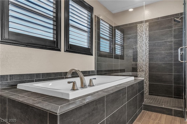 full bathroom with a stall shower and a garden tub