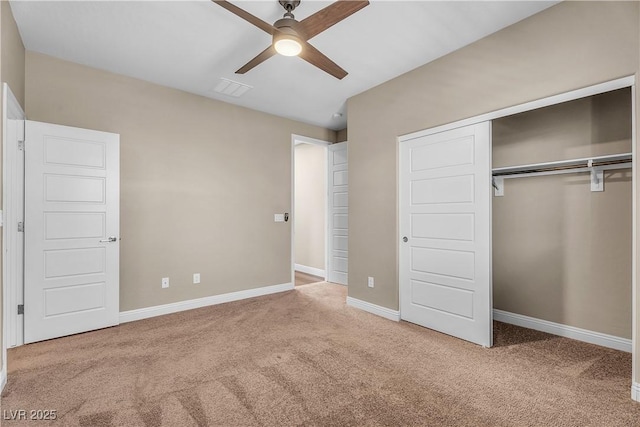 unfurnished bedroom featuring carpet flooring, a closet, baseboards, and ceiling fan