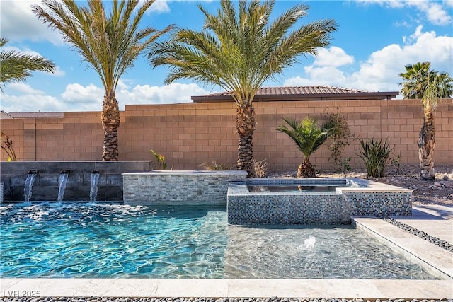 view of swimming pool with fence and a pool with connected hot tub