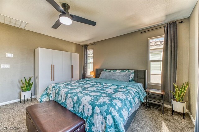bedroom with visible vents, baseboards, a ceiling fan, and carpet flooring