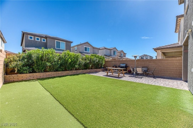 view of yard featuring a patio area and a fenced backyard