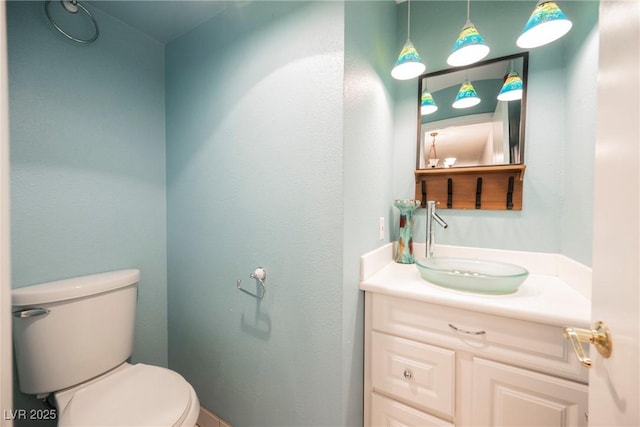 half bath featuring toilet and vanity