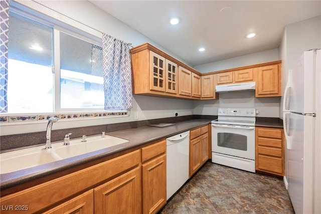 kitchen featuring a sink, dark countertops, glass insert cabinets, white appliances, and under cabinet range hood