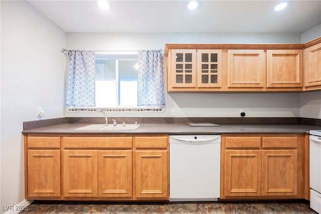 kitchen with white dishwasher, dark countertops, recessed lighting, and a sink