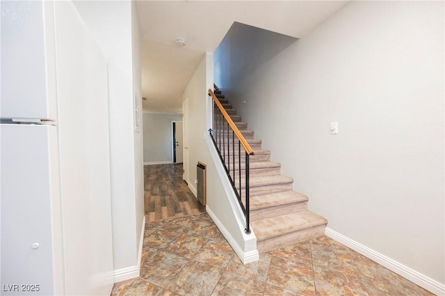 staircase featuring baseboards
