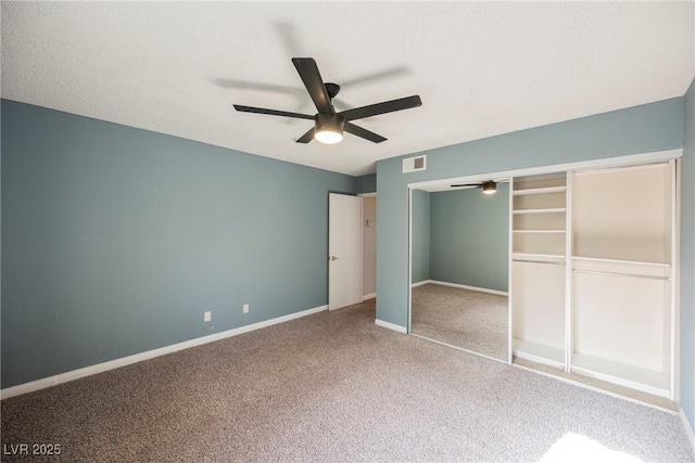 unfurnished bedroom featuring carpet flooring, baseboards, visible vents, a closet, and ceiling fan