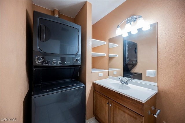 clothes washing area featuring stacked washer / drying machine, a sink, and laundry area