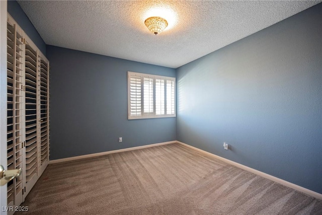unfurnished bedroom featuring baseboards, carpet floors, and a textured ceiling