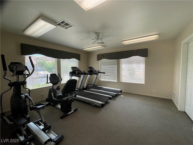 gym with ceiling fan, baseboards, and visible vents