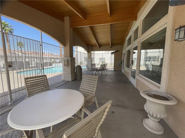 855 N Stephanie St Unit 112, Henderson, NV 89014 - view of patio / terrace with outdoor dining space, fence, and a community pool