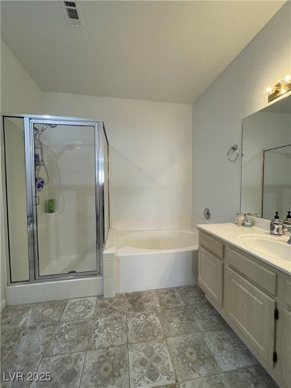 bathroom with a shower stall, visible vents, a garden tub, and vanity