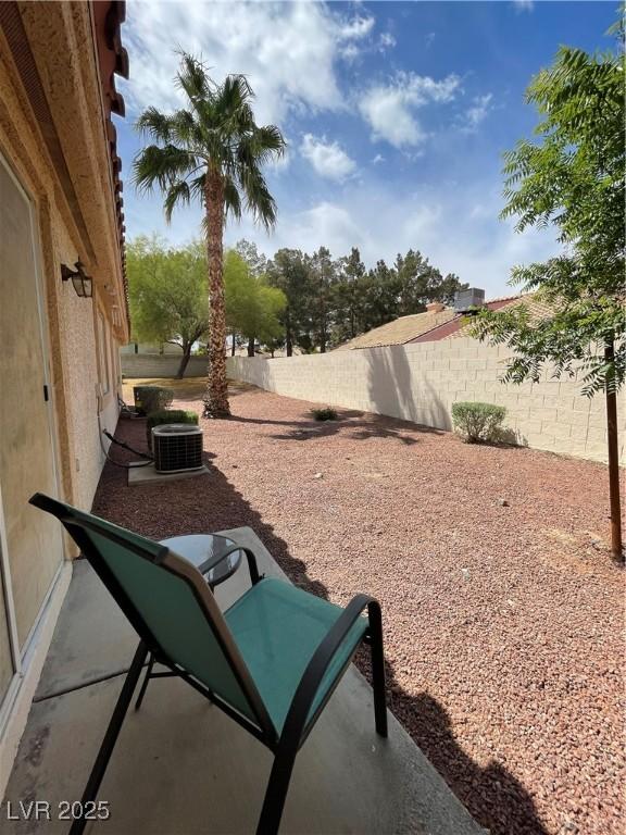 855 N Stephanie St Unit 112, Henderson, NV 89014 - view of patio / terrace featuring a fenced backyard and cooling unit