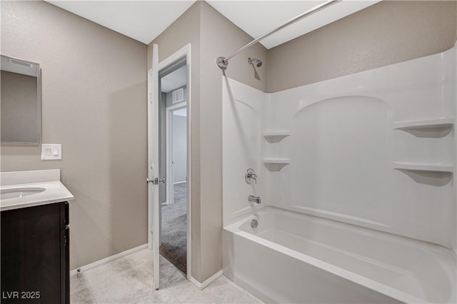 full bath with baseboards, vanity, and bathtub / shower combination