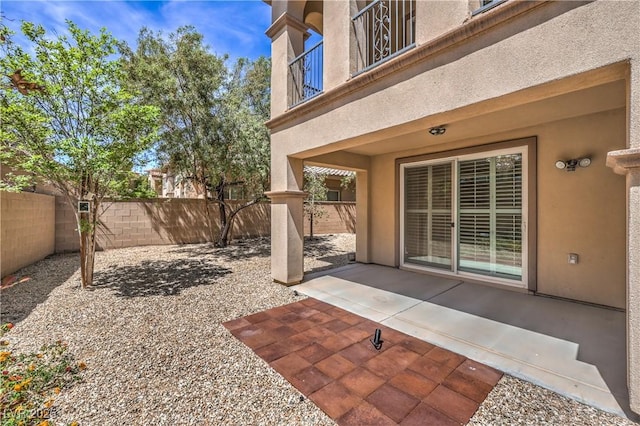 view of patio / terrace with a fenced backyard and a balcony