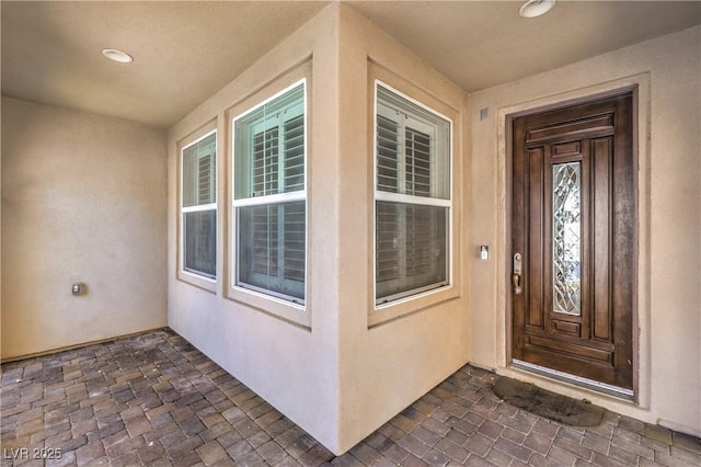 view of exterior entry featuring stucco siding
