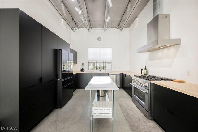 5077 Thunder River Cir, Las Vegas, NV 89148 - kitchen with stainless steel appliances, modern cabinets, wall chimney exhaust hood, dark cabinets, and light countertops