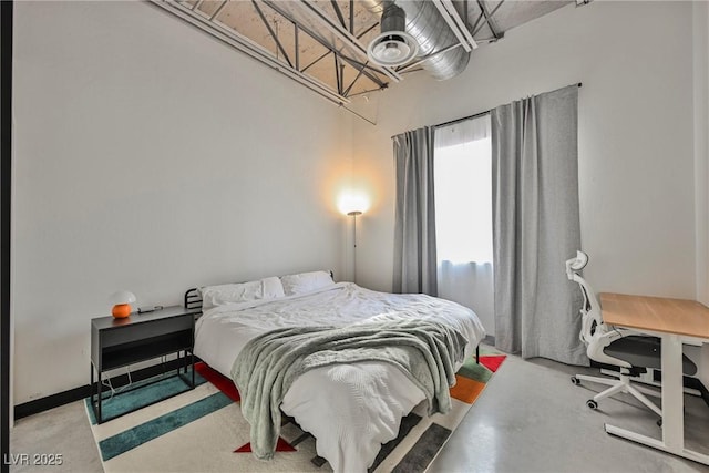 bedroom featuring finished concrete floors