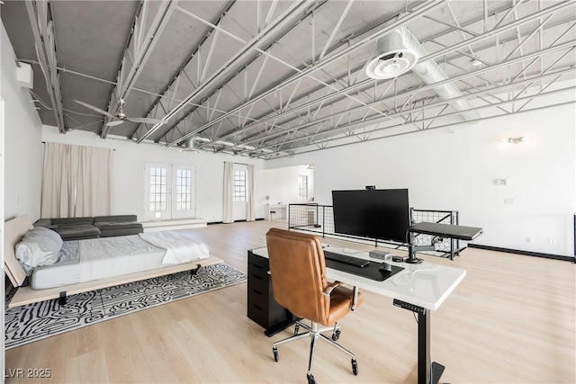 office area with baseboards and wood finished floors