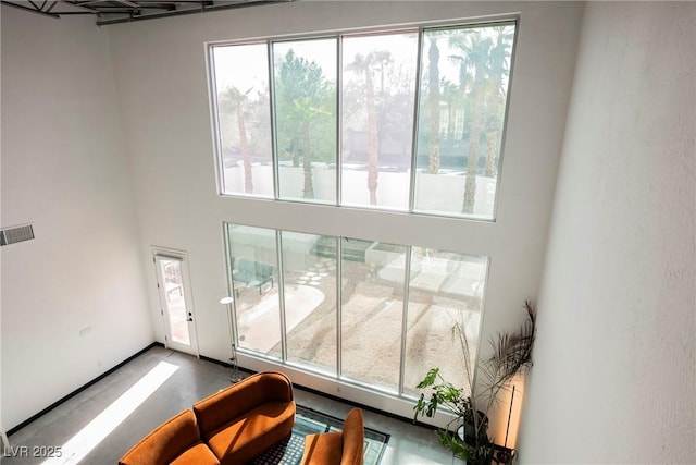 interior space featuring visible vents and a high ceiling