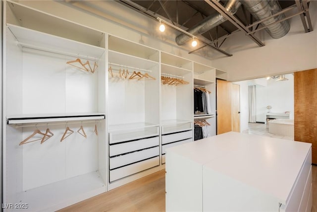 walk in closet featuring light wood-style flooring