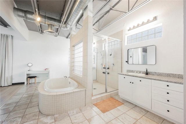 full bathroom featuring plenty of natural light, a shower stall, and a bath