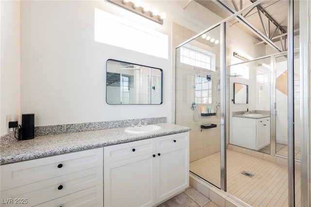 bathroom featuring vanity, tile patterned floors, and a stall shower