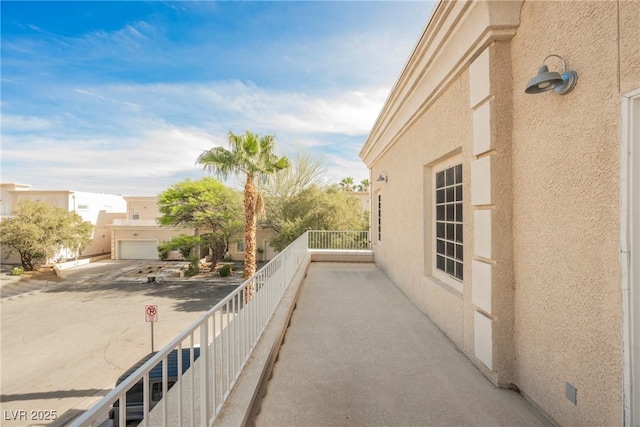 view of side of property with stucco siding and a balcony
