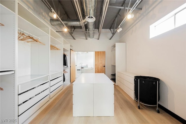 spacious closet featuring light wood finished floors