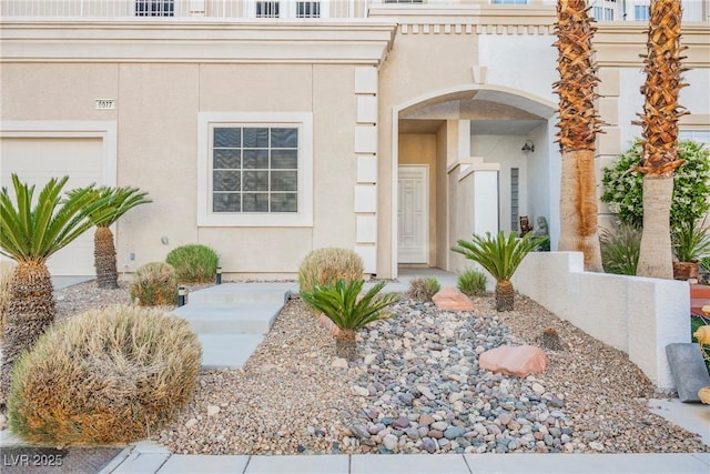 entrance to property with stucco siding