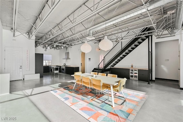 dining area featuring finished concrete floors and stairway