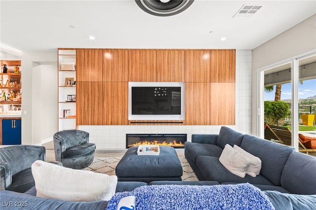 103 Reflection Cove Dr, Henderson, NV 89011 - living room with recessed lighting, a glass covered fireplace, and visible vents