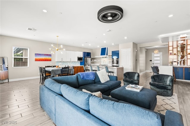 103 Reflection Cove Dr, Henderson, NV 89011 - living area featuring an inviting chandelier, light wood finished floors, baseboards, visible vents, and recessed lighting