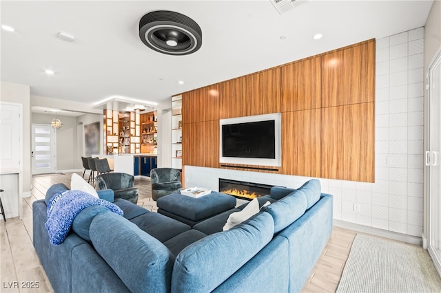 103 Reflection Cove Dr, Henderson, NV 89011 - living area featuring a glass covered fireplace, visible vents, and recessed lighting