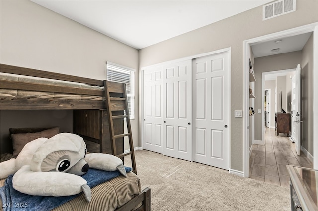 103 Reflection Cove Dr, Henderson, NV 89011 - bedroom with baseboards, light carpet, visible vents, and a closet