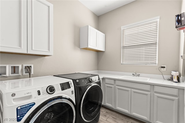 103 Reflection Cove Dr, Henderson, NV 89011 - laundry area featuring cabinet space, light wood-style floors, washer and dryer, and a sink
