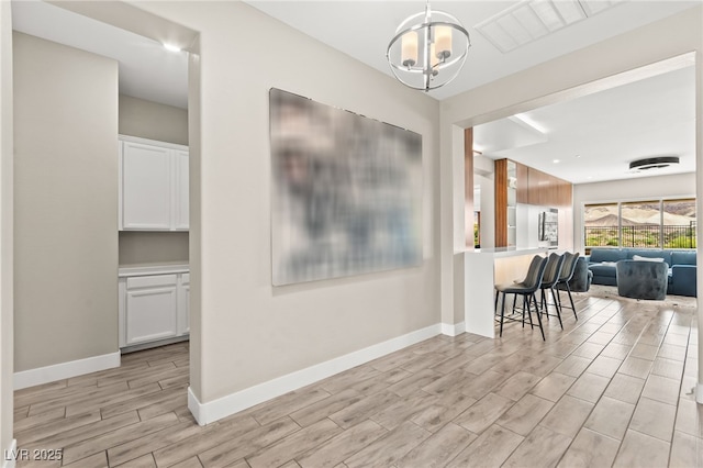 103 Reflection Cove Dr, Henderson, NV 89011 - dining area featuring visible vents, baseboards, wood tiled floor, and an inviting chandelier