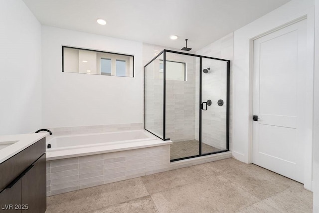 bathroom featuring a garden tub, vanity, recessed lighting, and a stall shower