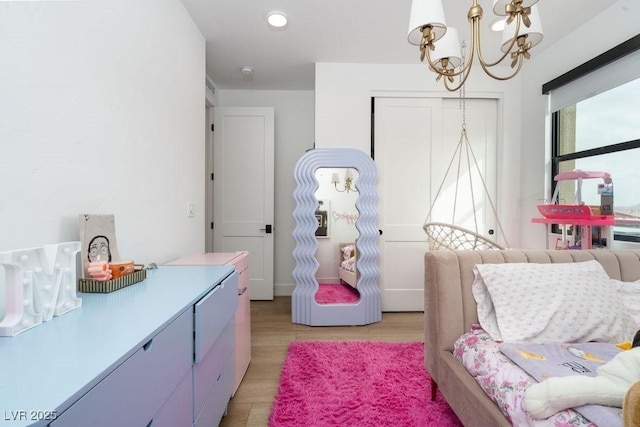bedroom with a chandelier, light wood-style flooring, a closet, and recessed lighting