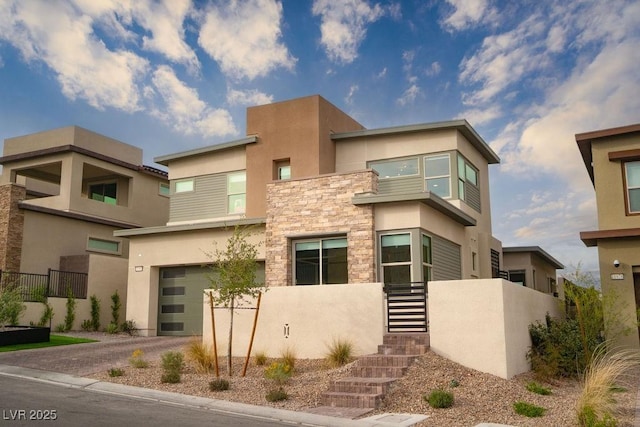 11990 Montague St, Las Vegas, NV 89138 - view of front facade featuring stucco siding, stone siding, a garage, and driveway