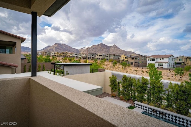 balcony featuring a mountain view and a residential view
